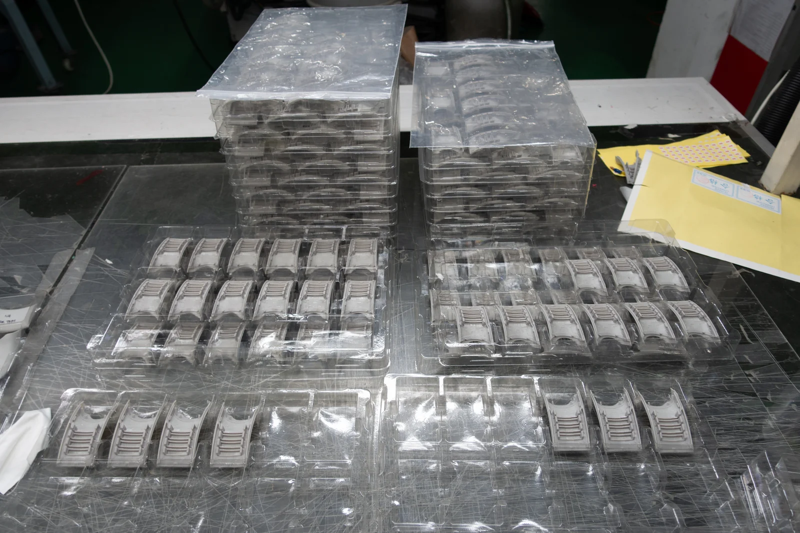 Parts at the trimming workstation, viewed from behind the operator's position.
