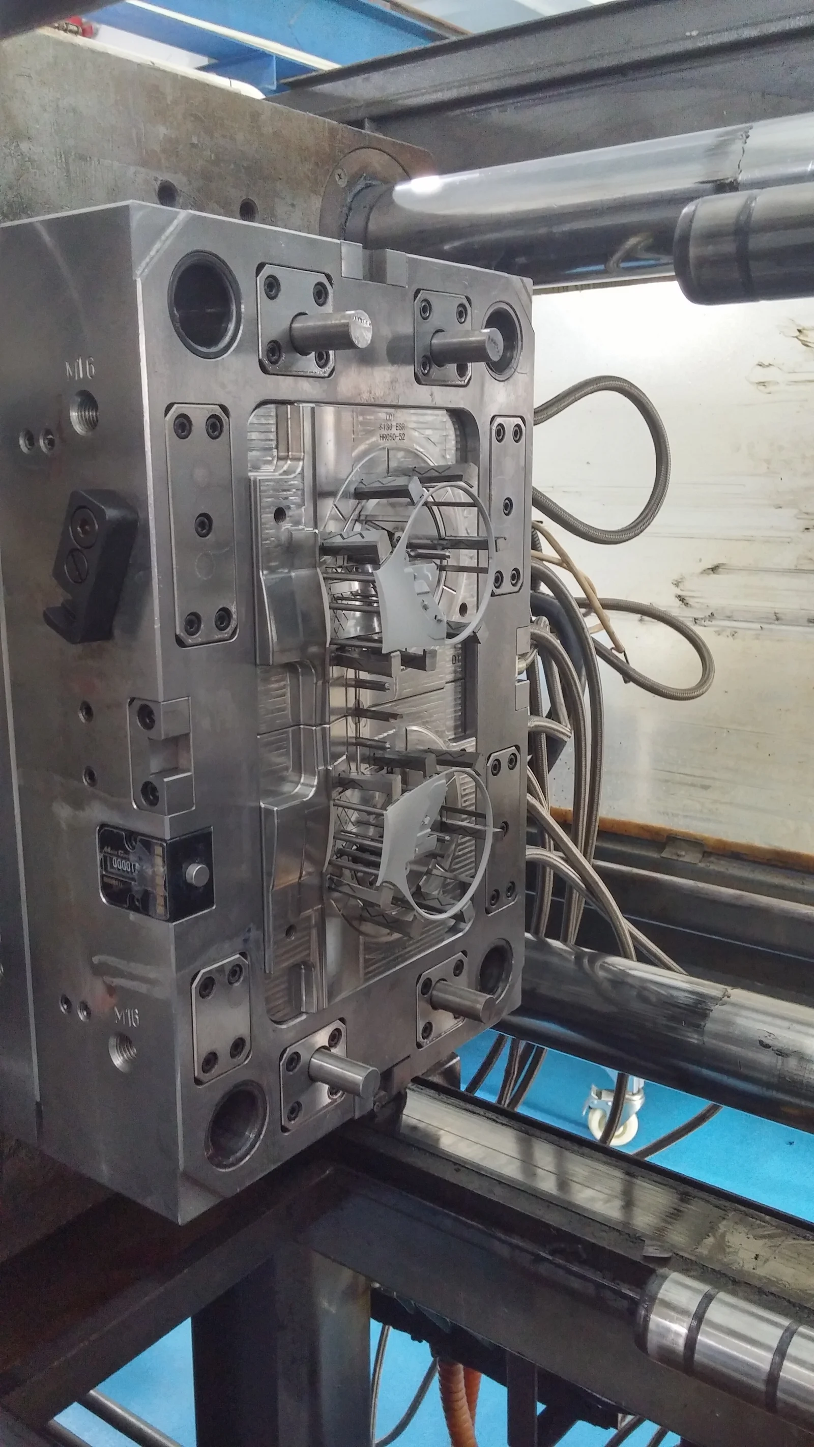 Earcan parts resting on the ejectors, ready for removal. Shortly afterward we implemented robotic part removal and degating for production.