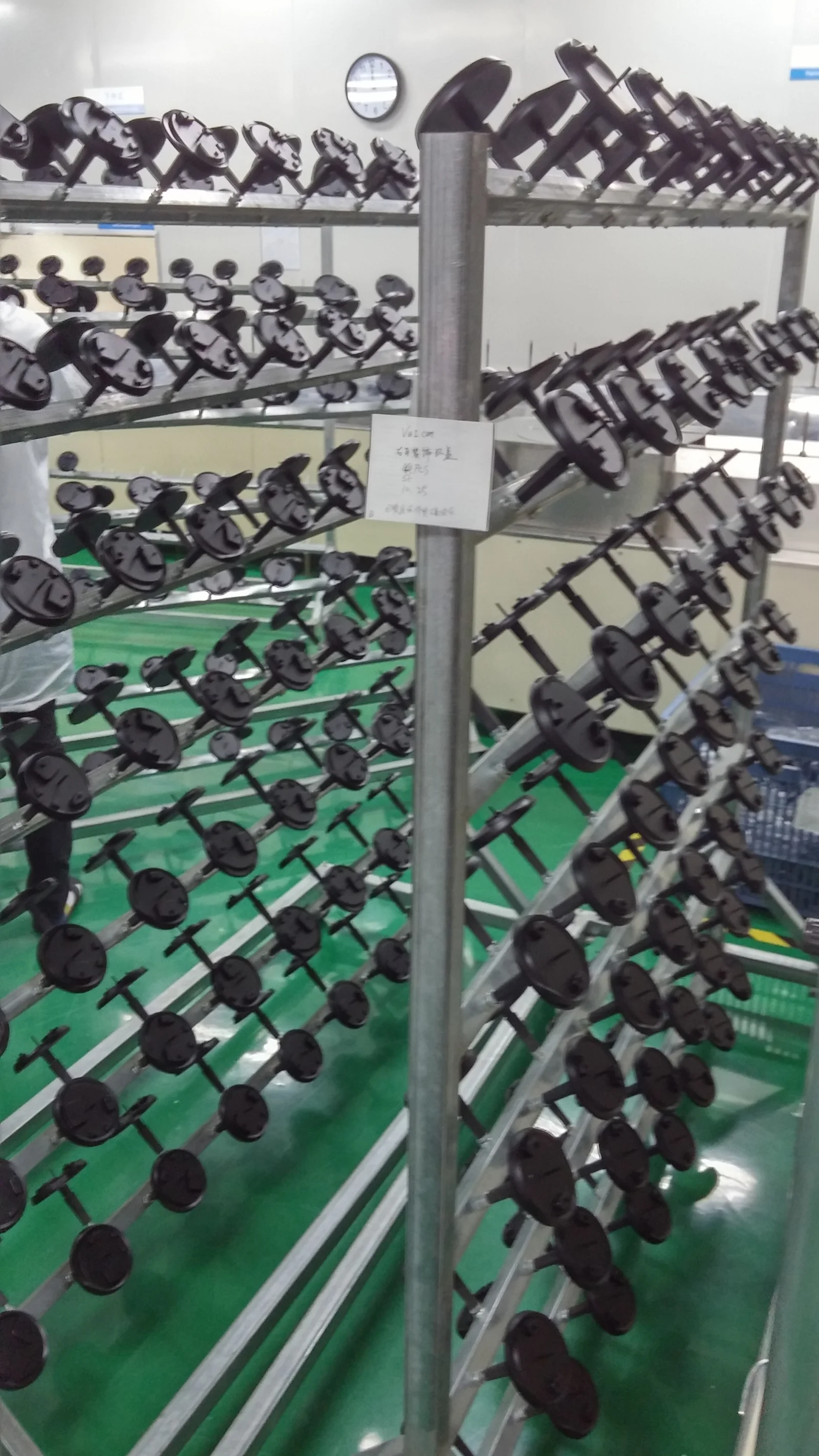 The paint-fixture arrangement across the finishing racks.