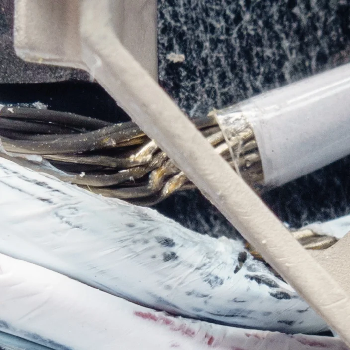 Detail of the same area: the local cable damage and contacting features.