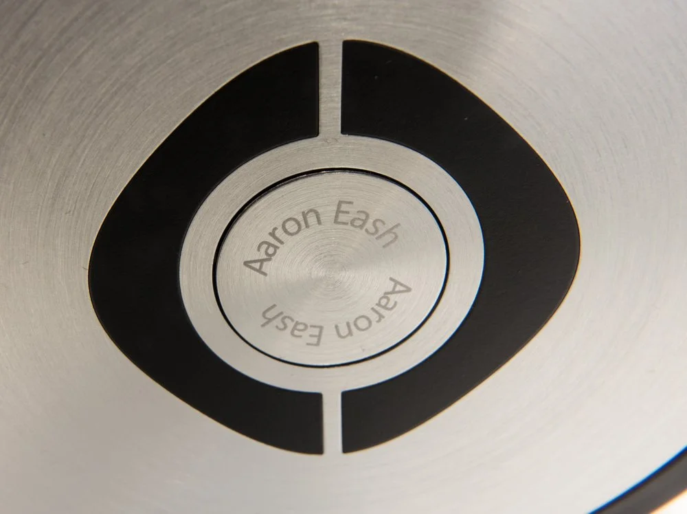 A photographed Glyph earcan with Aaron Eash's name on the aluminum center disc.