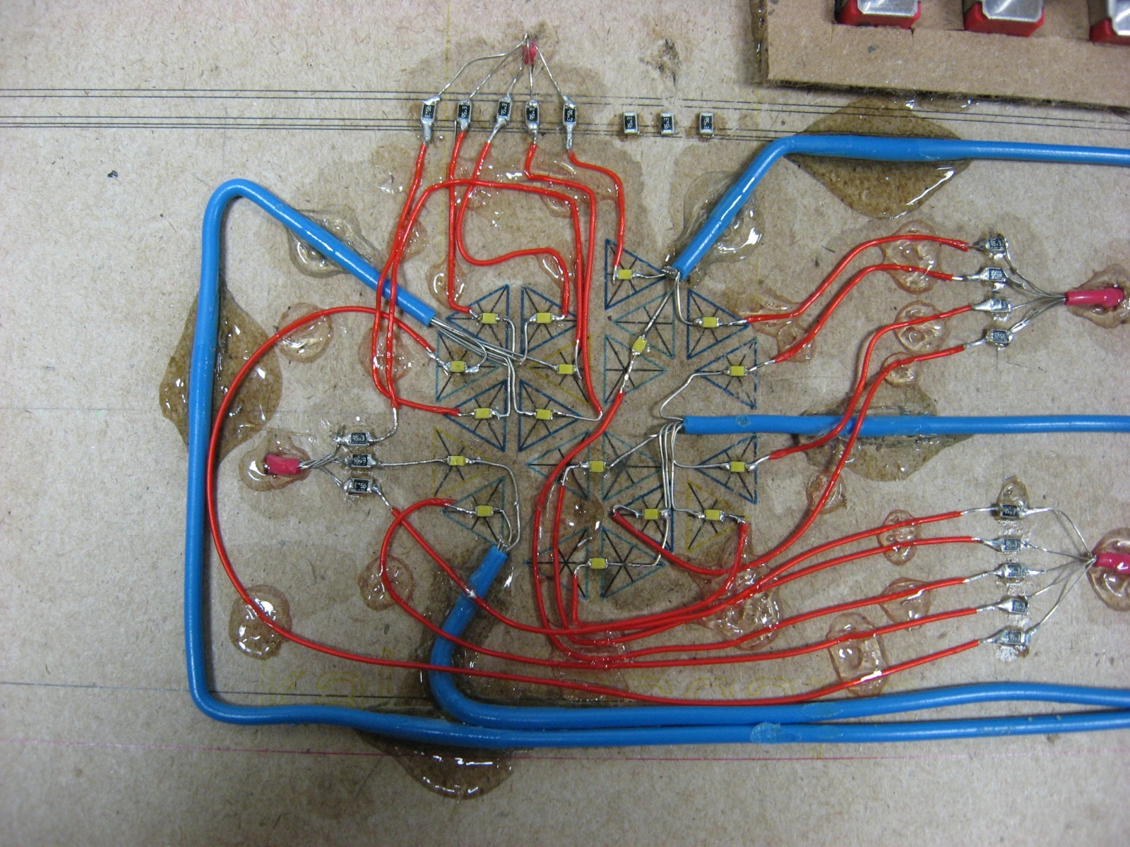 Hand-wired LEDs arranged over a drawn jewel pattern