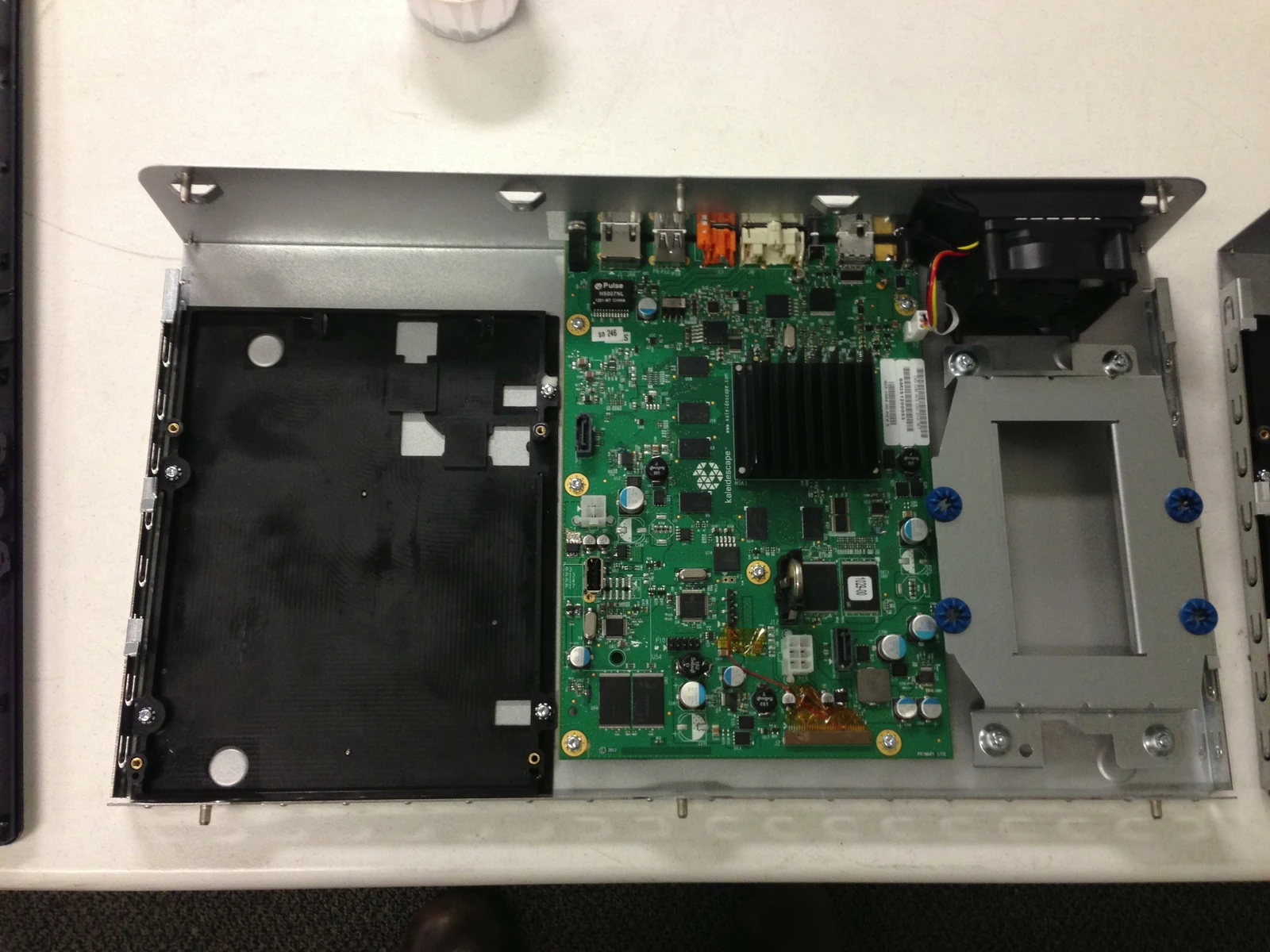 Open chassis showing mainboard, drive carrier and fan