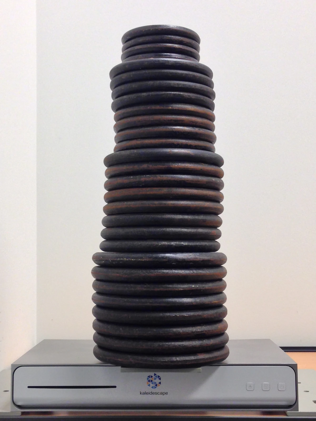 Stack of dumbbell plates on a Cinema One enclosure