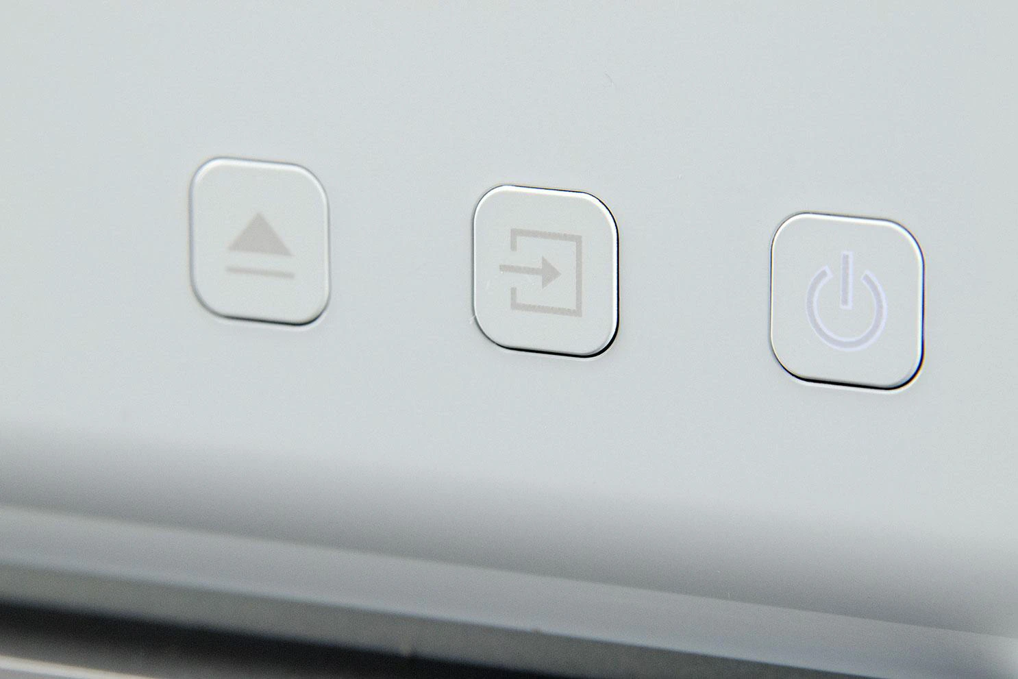 Three front buttons in the curved white face